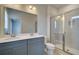Modern bathroom with dual vanity, large mirror, and a glass-enclosed shower stall at 529 Rubato Knl, Mcdonough, GA 30253