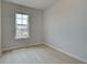 Bright bedroom with a large window, light-colored walls, and minimalist design, offering a serene space at 529 Rubato Knl, Mcdonough, GA 30253