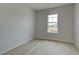Simple bedroom with light wood floors, a single window, and neutral walls providing a bright and airy feel at 529 Rubato Knl, Mcdonough, GA 30253