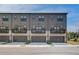 Contemporary townhome featuring a two-car garage, a private balcony, and sleek exterior finishes at 529 Rubato Knl, Mcdonough, GA 30253