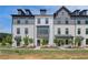 Beautiful townhomes with a combination of white brick and siding under a dark roofline for a sleek, modern aesthetic at 529 Rubato Knl, Mcdonough, GA 30253