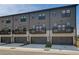 Well-maintained townhome showcasing a two-car garage, private balcony, and modern gray exterior at 529 Rubato Knl, Mcdonough, GA 30253