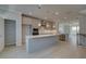 Spacious kitchen featuring gray cabinets, stainless steel appliances, a walk-in pantry and a large center island at 529 Rubato Knl, Mcdonough, GA 30253