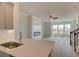 Bright living room features a modern fireplace, ceiling fan and large windows that bring in natural light at 529 Rubato Knl, Mcdonough, GA 30253