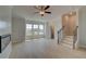 Bright living room with a modern fireplace, ceiling fan and a staircase at 529 Rubato Knl, Mcdonough, GA 30253