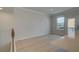 Bright living room with light wood-look floors and door to a balcony at 529 Rubato Knl, Mcdonough, GA 30253