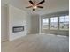 Bright living room with a modern fireplace and large windows at 529 Rubato Knl, Mcdonough, GA 30253