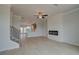 Bright living room with fireplace and ceiling fan, open to kitchen and natural light at 529 Rubato Knl, Mcdonough, GA 30253