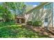 Backyard with a two-story house that includes a wood chimney, deck, and a garden area at 614 Springharbor Dr, Woodstock, GA 30188