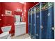 Cozy bathroom with red walls, white vanity and blue patterned shower curtain at 614 Springharbor Dr, Woodstock, GA 30188