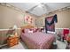 Well-decorated bedroom featuring neutral carpet, decorative items, and a wicker bed frame at 614 Springharbor Dr, Woodstock, GA 30188
