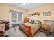 Comfortable bedroom with wood-frame bed, window, ceiling fan, and neutral carpet at 614 Springharbor Dr, Woodstock, GA 30188