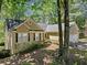 Side view of a home with a stucco exterior and a well-maintained lawn and landscaping at 614 Springharbor Dr, Woodstock, GA 30188