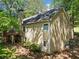 Side view of a two-story house with a wood chimney, deck, and well-maintained outdoor at 614 Springharbor Dr, Woodstock, GA 30188