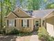 Close up of a charming one-story home with a well-manicured front yard and inviting entrance at 614 Springharbor Dr, Woodstock, GA 30188