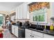 Kitchen with white cabinets, granite counters and a large window with a view at 614 Springharbor Dr, Woodstock, GA 30188