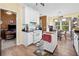 Spacious kitchen with white cabinets, wood floors, island and open to the living room at 614 Springharbor Dr, Woodstock, GA 30188