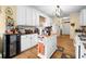 Kitchen featuring white cabinets, stainless appliances, wood floors and a kitchen island at 614 Springharbor Dr, Woodstock, GA 30188