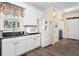 Bright kitchen featuring white cabinetry, stainless appliances and wood floors at 614 Springharbor Dr, Woodstock, GA 30188