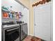 Bright laundry area with modern appliances and ample shelving for storage at 614 Springharbor Dr, Woodstock, GA 30188