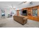 Spacious living room with built-in wooden shelving, a couch, and a ceiling fan at 614 Springharbor Dr, Woodstock, GA 30188