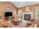 Cozy living room with vaulted ceilings, featuring a fireplace and comfortable seating arrangement at 614 Springharbor Dr, Woodstock, GA 30188