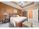 Bedroom features neutral carpet, a ceiling fan, earth-tone walls, and access to ensuite bathroom at 614 Springharbor Dr, Woodstock, GA 30188