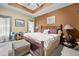 Cozy bedroom with a ceiling fan, brown accent wall, carpet, and side tables with lamps at 614 Springharbor Dr, Woodstock, GA 30188