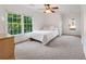 Bedroom with natural light from windows, carpet flooring, and neutral wall color at 7115 Doncaster Ct, Cumming, GA 30040
