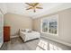 Bright bedroom featuring a vaulted ceiling, hardwood floors, and natural light from the window at 7115 Doncaster Ct, Cumming, GA 30040