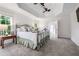 Spacious bedroom with tray ceilings, carpet, and a large window with natural light at 7115 Doncaster Ct, Cumming, GA 30040
