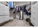 Spacious walk-in closet with custom shelving and drawers for optimal storage, and a mirror at 7115 Doncaster Ct, Cumming, GA 30040