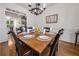 Charming dining room featuring hardwood floors, wainscoting and elegant chandelier lighting at 7115 Doncaster Ct, Cumming, GA 30040