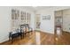 Inviting entryway with hardwood floors, bench seating, a welcome sign, and natural light from large windows at 7115 Doncaster Ct, Cumming, GA 30040