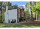 Side view of a brick and siding house with manicured lawn and mature trees at 7115 Doncaster Ct, Cumming, GA 30040