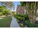 Charming brick home with lush landscaping, featuring a curved walkway and inviting curb appeal at 7115 Doncaster Ct, Cumming, GA 30040