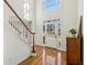 Grand foyer with soaring ceilings, hardwood floors, staircase, and natural light at 7115 Doncaster Ct, Cumming, GA 30040