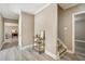 Inviting hallway with neutral walls, hardwood floors, and accent furniture and decor at 7115 Doncaster Ct, Cumming, GA 30040