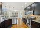 Stylish kitchen equipped with stainless steel appliances, dark cabinets, and bright lighting at 7115 Doncaster Ct, Cumming, GA 30040