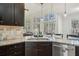 Bright kitchen features granite countertops, stainless steel appliances, and large windows with natural light at 7115 Doncaster Ct, Cumming, GA 30040