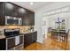 Well-appointed kitchen showcasing stainless steel appliances and dark cabinetry at 7115 Doncaster Ct, Cumming, GA 30040