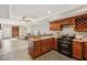 Charming kitchen with wood cabinets, tile floors and stainless steel oven at 7115 Doncaster Ct, Cumming, GA 30040
