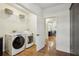 Functional laundry room with modern appliances, shelving, and access to the kitchen at 7115 Doncaster Ct, Cumming, GA 30040