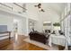 Open living room with fireplace, soaring ceilings, large windows, and hardwood floors at 7115 Doncaster Ct, Cumming, GA 30040