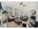 Spacious living room with large windows, hardwood floors, and views to the outdoor greenery at 7115 Doncaster Ct, Cumming, GA 30040