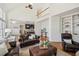 Cozy living room featuring hardwood floors, fireplace and built-in shelving at 7115 Doncaster Ct, Cumming, GA 30040