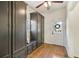 Mudroom with built-in storage, bench seating, tile floors, and access to the exterior at 7115 Doncaster Ct, Cumming, GA 30040