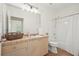Well-lit bathroom with tile countertops, bathtub-shower, and vanity with a large mirror and ample storage space at 10 Perimeter Summit Ne Blvd # 2207, Brookhaven, GA 30319