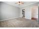 Spacious bedroom with soft carpeting, ceiling fan, and an ensuite bathroom for added convenience at 10 Perimeter Summit Ne Blvd # 2207, Brookhaven, GA 30319