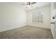 Comfortable bedroom featuring a ceiling fan, large window, and neutral carpeting for a cozy atmosphere at 10 Perimeter Summit Ne Blvd # 2207, Brookhaven, GA 30319